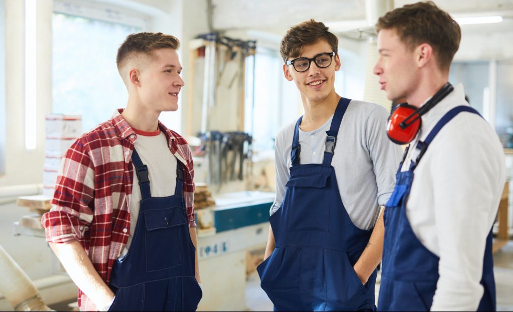 Positive carpentry students discussing their last work